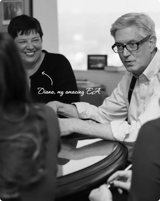 Doug at a meeting table with two people. An arrow points to a smiling woman with the text - Diana, my amazing EA